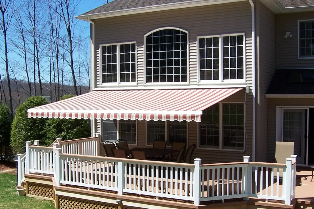 Red and cream striped retractable awning extended over a raised deck