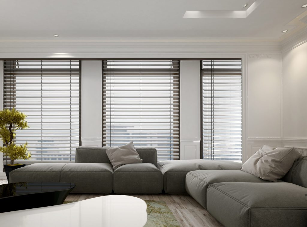 Luxury apartment living room interior with large floor to ceiling window blinds and soft gray modular sofa. Includes large gr