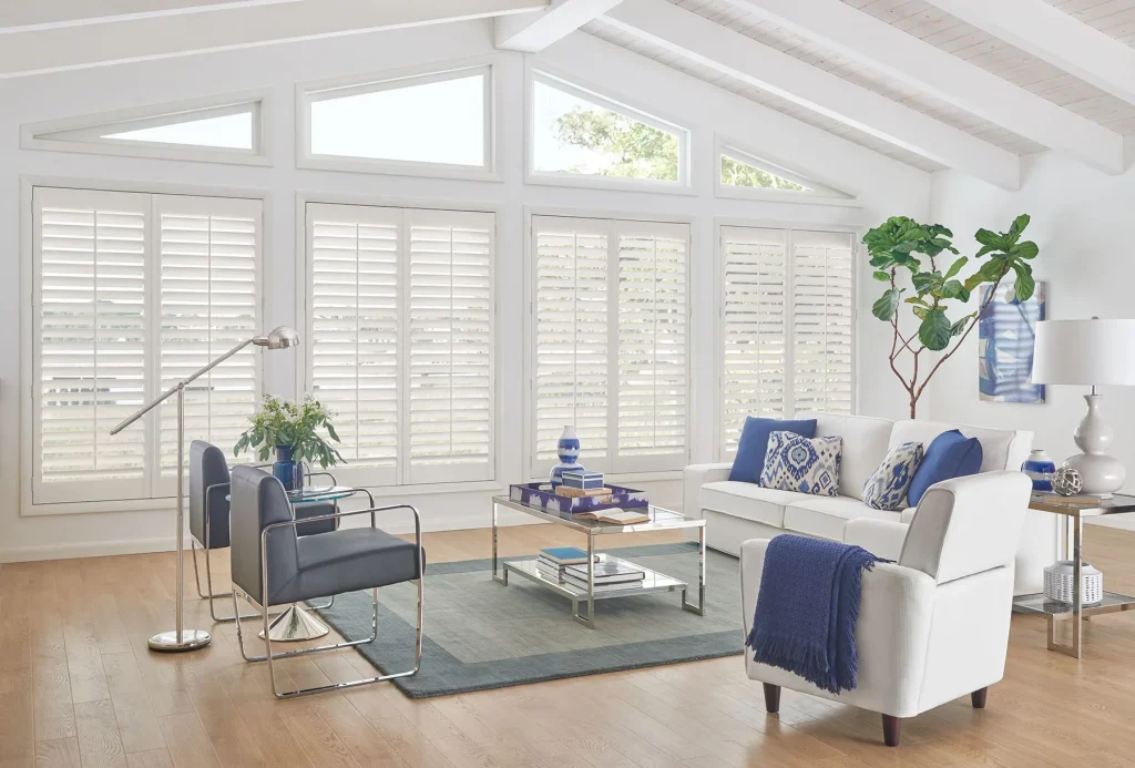 White plantation shutters across a living-room window wall