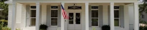 front entrance of home with American flag